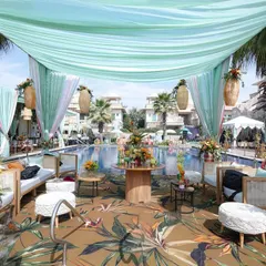 Daytime events call for a different kind of magic. For this poolside mehndi, I created a tropical oasis with breezy aqua drapes, natural cane furniture, and vibrant floral arrangements, designing a relaxed yet chic atmosphere for guests to enjoy under the sun.