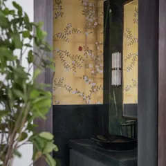 A jewel-box powder room in Hyderabad. We paired rich avocado green marble with delicate hand-painted walls and soft alabaster sconces to create a small space that is full of drama and impact.