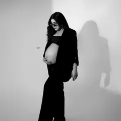 A cool, editorial-style black and white shot. The sunglasses and pose give this maternity photo a serious "swag game on point" vibe.