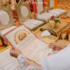 The sacred rituals are the soul of the wedding. Here, a family member holds the wedding invitation during the ceremony, a beautiful detail connecting the promise of the invitation to the reality of the vows.