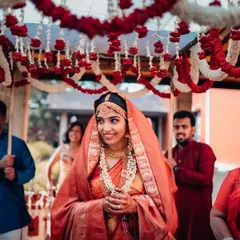 The bride's joyful entrance under a beautiful 'phoolon ki chadar'. We capture the anticipation and happiness of this iconic wedding moment.