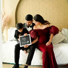 A sweet announcement photo with the soon-to-be big brother holding a "Baby on Board" sign. It's a lovely way to include the whole family in the excitement of the maternity journey.