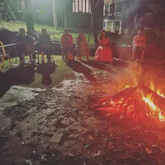 Our community gathered around a bonfire at night. These moments of shared ritual and chanting under the stars create a deep sense of spiritual connection and friendship.