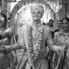 The groom's joyful entrance, full of energy and style. This black and white shot captures the excitement of the Baraat.