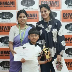 A young winner with his mother and teacher, holding his certificate and trophy. These moments of recognition are a key part of building a child's confidence.