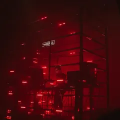 I love playing in unique settings. Here I am inside a custom LED cage at a show in Bombay, surrounded by red lights. This kind of immersive audio visual setup helps me build a deep, hypnotic techno journey for everyone in the room.