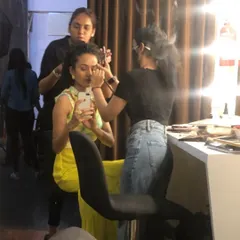 Working alongside a hair stylist to get the talent ready. Collaboration is at the heart of what I do, as we all work together to create the perfect look.