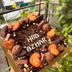 My signature loaded brownie slab is a dream come true for any chocolate lover. I start with a fudgy, eggless brownie base and then load it up with an assortment of treats like KitKat bars, Oreo cookies, Ferrero Rocher, and crispy little heart biscuits. It's a fantastic and fun alternative to a traditional birthday cake.