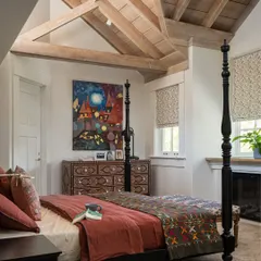 A bedroom should be your personal retreat. For this Saratoga home, I designed a sanctuary with a classic four-poster bed, an intricately designed inlay console, and warm, textural layers. The vaulted wood-beamed ceiling adds a sense of rustic grandeur, making the space feel both cozy and expansive.