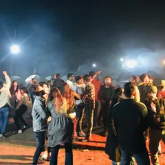The night comes alive at our camps. Here, guests are gathered around a bonfire, dancing and connecting under the stars. This is the social heart of our lakeside events.