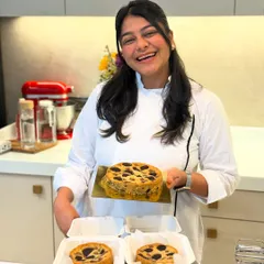 Me, holding up the results of our viral eggless butter cake workshop. It's a super easy recipe that anyone can can make, even without baking experience.