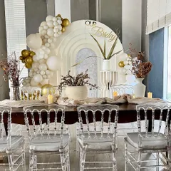 A closer look at the elegant boho bridal shower we styled for Kavya. The decor features a neutral palette with white and gold balloons, dried floral arrangements, and clear ghost chairs for a sophisticated look.