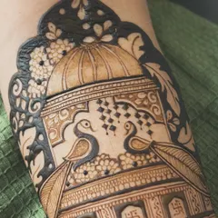 And here is the design after filling. The dark, bold henna paste creates a beautiful contrast with the fine lines, bringing the peacocks and the palace dome to life.
