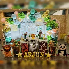 A fun jungle safari theme for Arjun's second birthday, with cute cartoon animal props like a lion, panda, and giraffe.