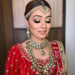 A closer look at Bhavika's traditional bridal makeup, showcasing the sharp winged liner and soft contour that enhances her features beautifully.