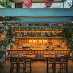 A view of our main bar area, ready for the evening. The high ceilings and open layout can accommodate larger groups, while the warm lighting and wooden textures maintain an intimate feel.
