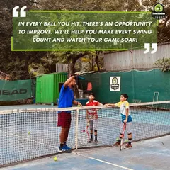 A coach provides hands-on instruction to young players at the net. We believe every ball you hit is an opportunity to improve, and we're here to make every swing count.