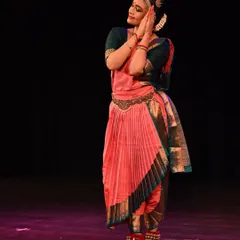 A graceful pose from a solo Bharatanatyam recital. The dancer's serene expression and elegant posture capture the devotional aspect of the dance.