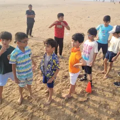 The team huddles up on the sand before a game. We bring the games and gear, you just bring the kids!