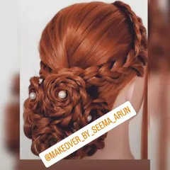 This intricate bun features multiple braided roses and is accented with pearls. It's a sophisticated and unique choice for a bride or wedding guest.