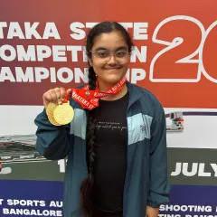 We celebrate every victory. Here, our shooter Vaishnavi proudly displays her three gold medals from the Karnataka State Shooting Championship, a result of her incredible dedication and our advanced coaching.