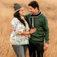 Dressed in cozy winter wear, this couple shares a look of love amidst a field of golden grass. My sessions are relaxed, allowing for natural interactions like this that truly reflect the connection between two people.