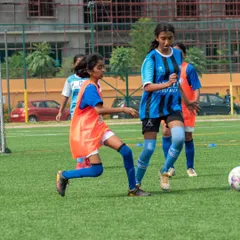 A young player from our sub-junior team focuses on the ball, demonstrating the determination we instill in our future stars.
