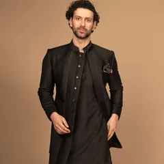 A sleek, black Indo-Western ensemble. The structured jacket paired with a kurta offers a sophisticated look that is perfect for evening events, combining modern tailoring with traditional roots.