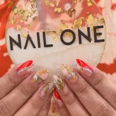 A close-up of our intricate bridal nail art. You can see the delicate gold leaf patterns and the sparkling silver accents that make this design so special and perfect for a wedding.