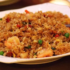 In addition to Indian cuisine, I also offer a selection of vegetarian Asian dishes. This is a plate of my vegetable fried rice, a versatile and popular option for social gatherings that adds a touch of global flavor to the menu.