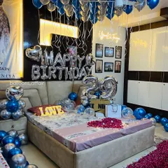 This is one of my most requested birthday decoration packages. The room is filled with metallic blue and silver helium balloons, with large foil balloons for the age and a "Happy Birthday" message, creating a full and festive atmosphere.