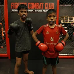 Brothers in arms, ready for the grind. These young fighters are learning discipline and determination with every session, wearing their mouthguards and gloves for a serious training day.