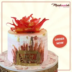 Indulge in the magic of Belgian chocolate. This stunning birthday cake is topped with a dramatic, handmade red sugar sail and finished with a textured buttercream and gold leaf.