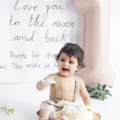 Let them eat cake! A first birthday cake smash is all about capturing pure, messy joy. This little one is having the time of his life during his minimalist-themed cake smash session at our studio.