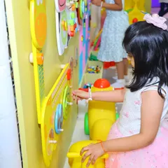 Our interactive wall is perfect for toddlers and young children to engage their senses. This little one is exploring different sounds and textures on our musical guitar panel.