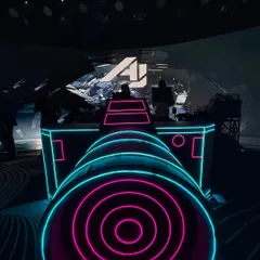 A unique perspective of my DJ console, designed to look like a futuristic cannon. The neon pink and blue lights give a glimpse of the high tech aesthetic I bring to my events.