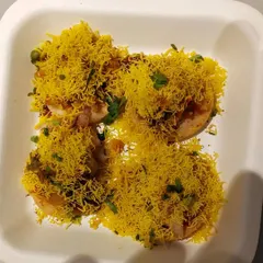 A close up of my freshly prepared Sev Puri. Each bite is a burst of flavor, made with crisp puris, tangy chutneys, and a generous topping of sev. It's a perfect example of the authentic Mumbai street food I can bring to your gathering.
