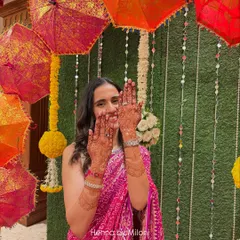 The beautiful 24-hour henna stain on my bride, perfectly complementing her pink bandhani saree. Seeing my clients this happy is the best reward.