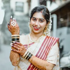 This bride is ready for her Kerala Kalyanam. I draped her cream and red-bordered saree in the traditional Kerala style, which pairs beautifully with her henna and classic wedding bangles.