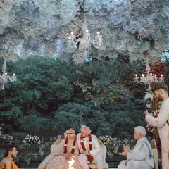 A magical ceremony setup under a dense canopy of white flowers and elegant chandeliers. The design created an enchanted forest feeling, providing a serene and romantic atmosphere for the couple's vows.