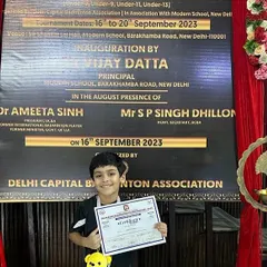 A young champion in the making. Advit Mishra proudly displays his certificate from the Delhi Capital Badminton Association, marking a significant milestone in his budding career.