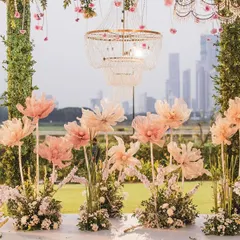 A detailed view of the mandap decor, focusing on the delicate, handcrafted paper flowers and the elegant birdcage-style chandeliers. Every element was chosen to create a soft, romantic, and picturesque setting.