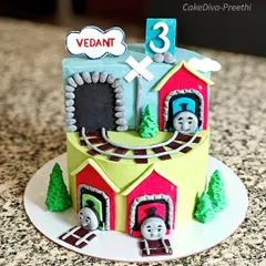 All aboard for a Thomas the Train party. This cake features Thomas and friends coming out of tunnels, with a fluffy vanilla sponge and blueberry filling inside.
