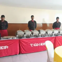 Our team ready behind a full buffet line that includes a live counter, perfect for house parties and get-togethers.