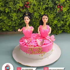 Double the fun with this Barbie cake featuring two dolls in pink gowns. It's perfect for a shared birthday party or for a girl who just loves Barbie.