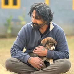 Holding this small puppy, I'm reminded that every animal, no matter how small, has a huge presence. My focus is entirely on its comfort and security, creating a silent dialogue of reassurance.