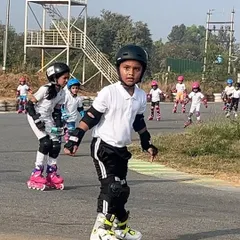 A young skater looking focused during an outdoor training session. We build confidence by practicing in different environments.
