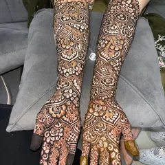 A closer look at the detailed bridal henna for Tuba, showcasing the fine lines and shading on her hands and arms.