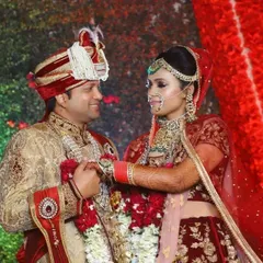 Another look at this gorgeous couple on their wedding day. The groom's coordinated sherwani complements the bride's Aarna designer label lehenga perfectly.