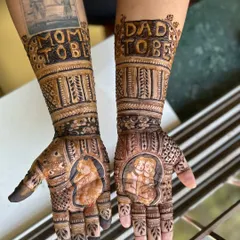 This custom baby shower mehendi for the "Mom to be" and "Dad to be" is one of my favorites. It includes portraits of the couple with their baby and even a recreation of a treasured family photo on the arm.